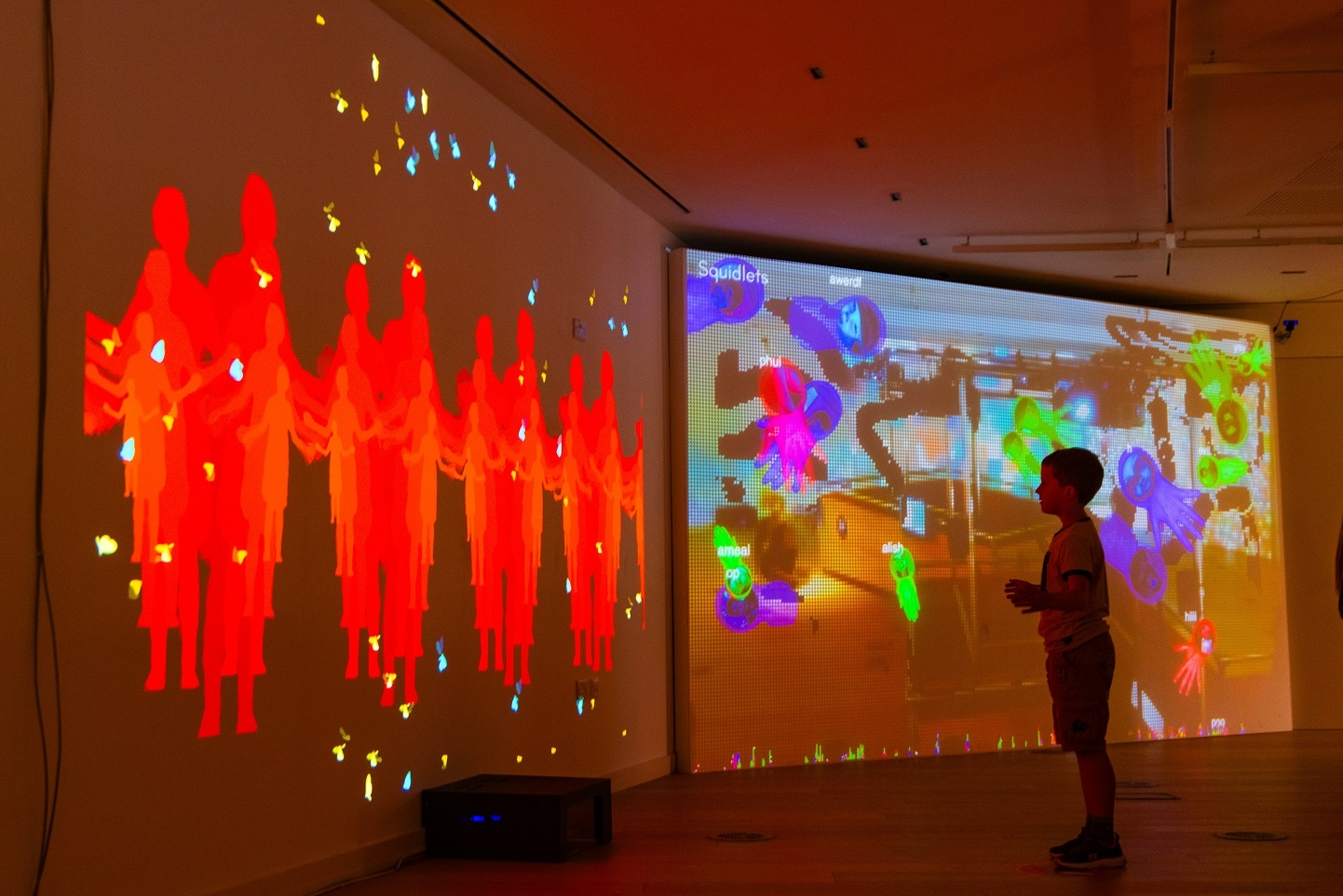 A child interacts with an artwork at Microworld: Amelia