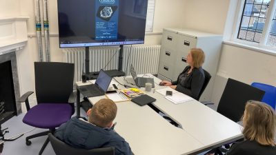 3 people watching a video - Learning about marketing
