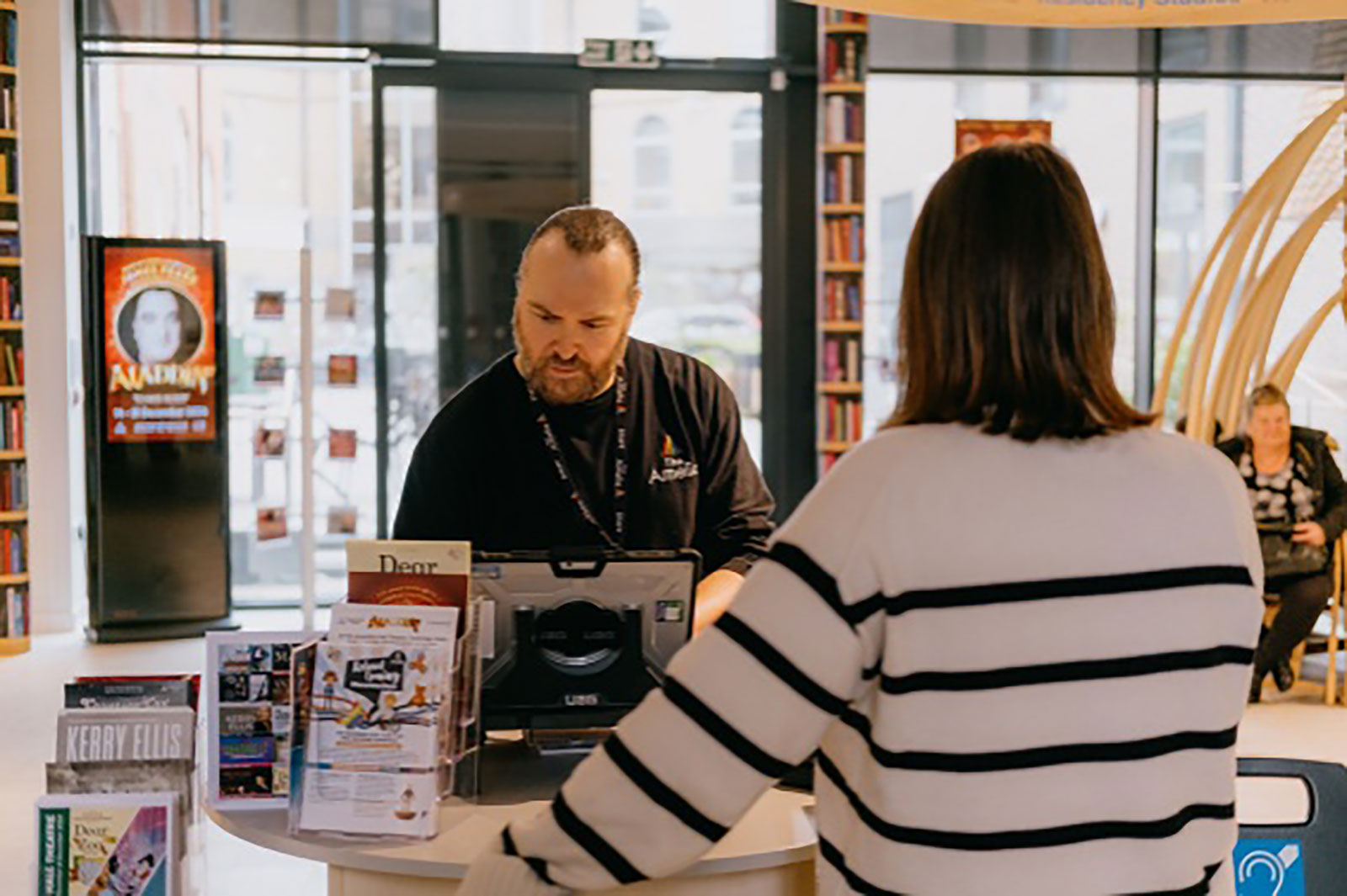 Front desk at The Amelia Scott with a team member serving a customer