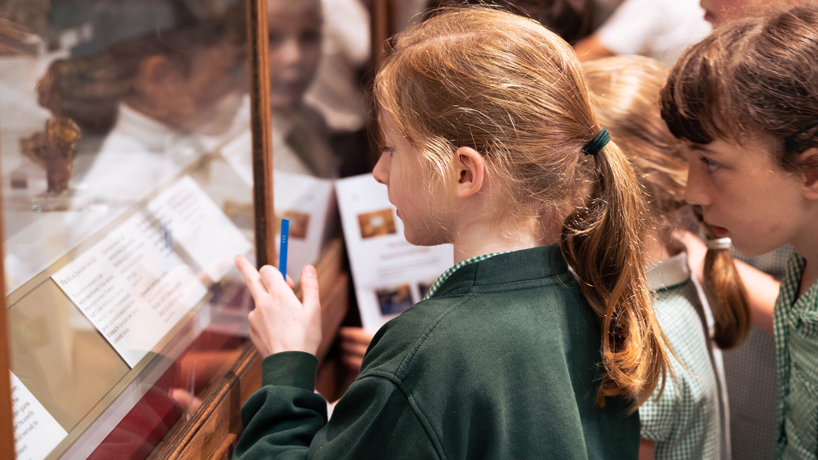 Pupils studying pre-historic artefacts