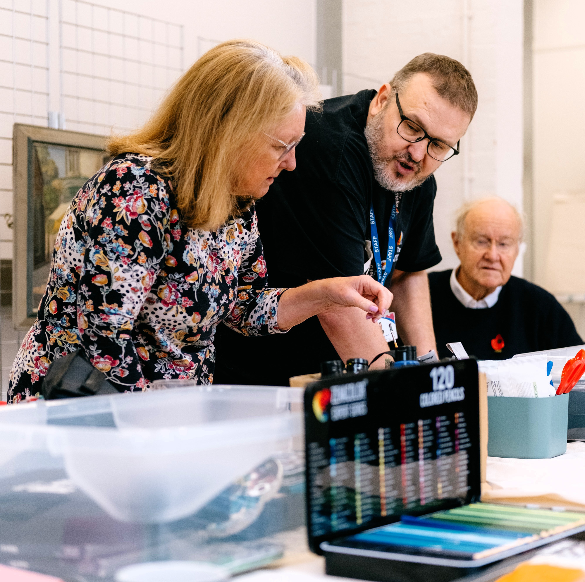3 people working on art