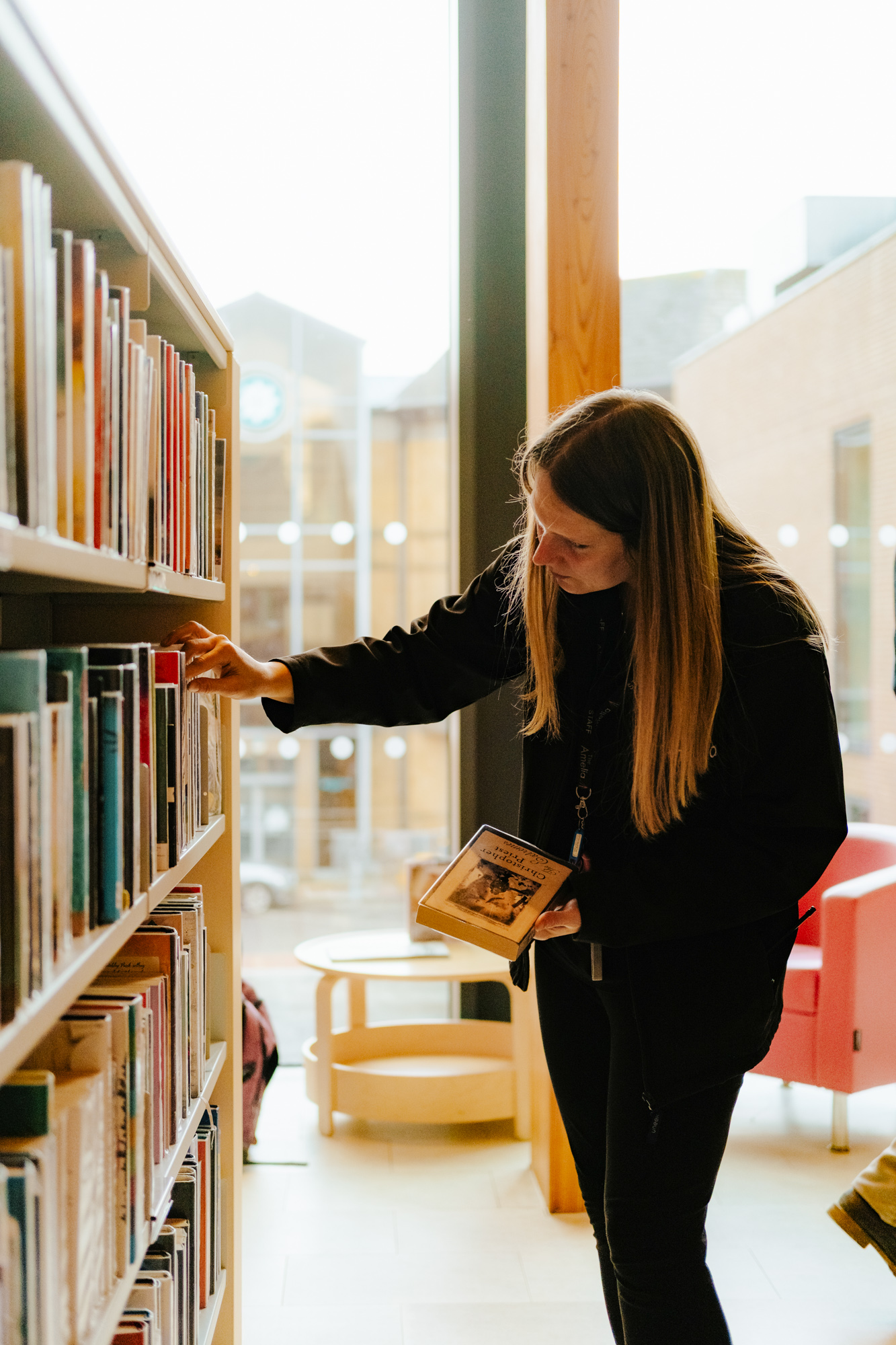 TheAmelia-General-27 Female choosing library books