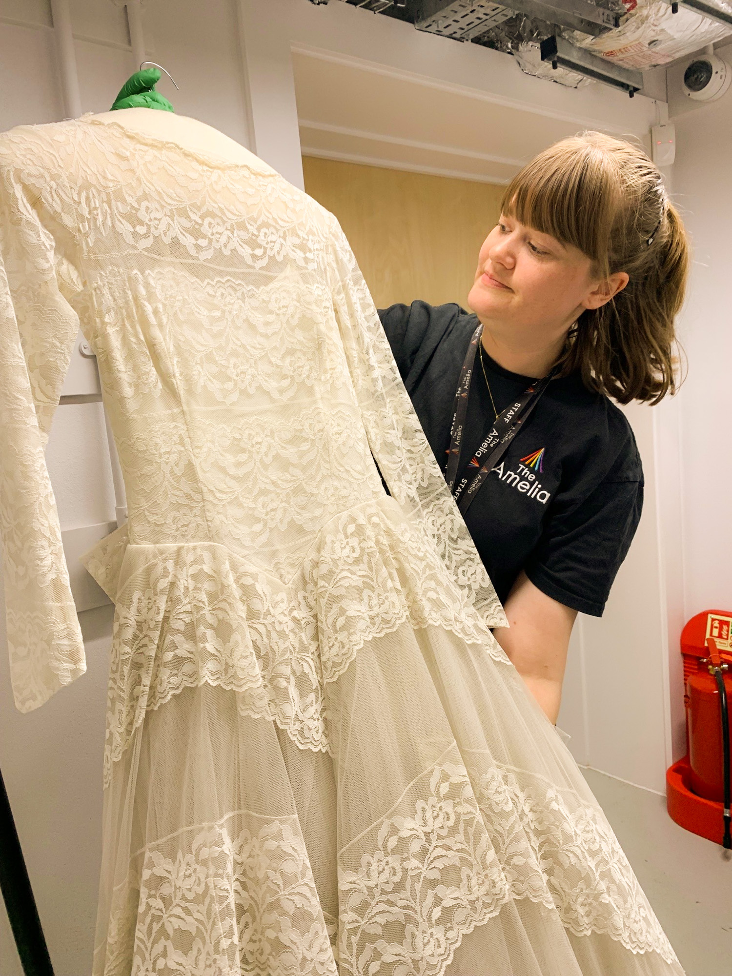 wedding dress A historical wedding dress being handled by a member of the Amelia team