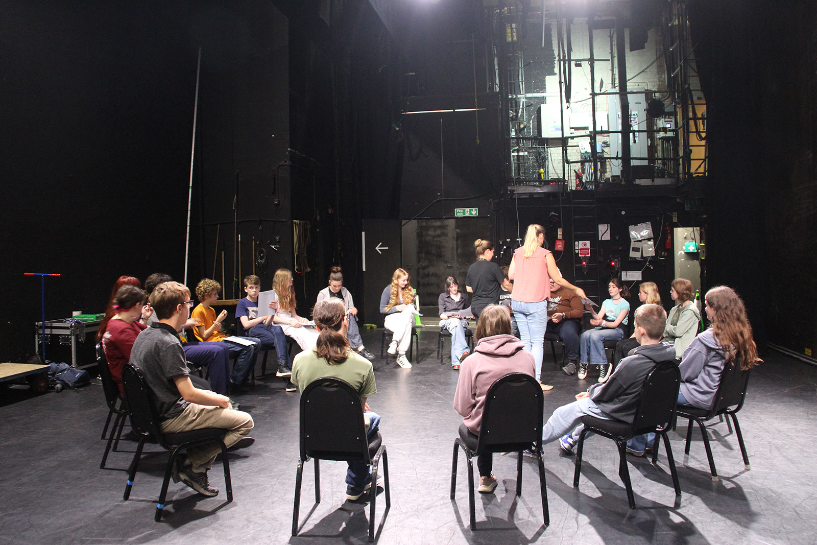 a class for young creatives with a large group sitting in a circle