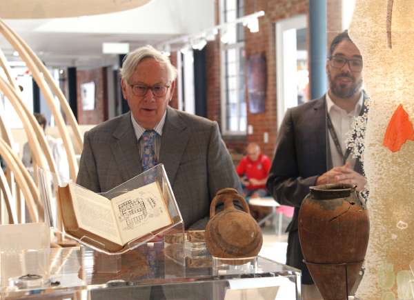 Shot 002 The Duke of Gloucester looking at some archaeology objects in a glass cabinet
