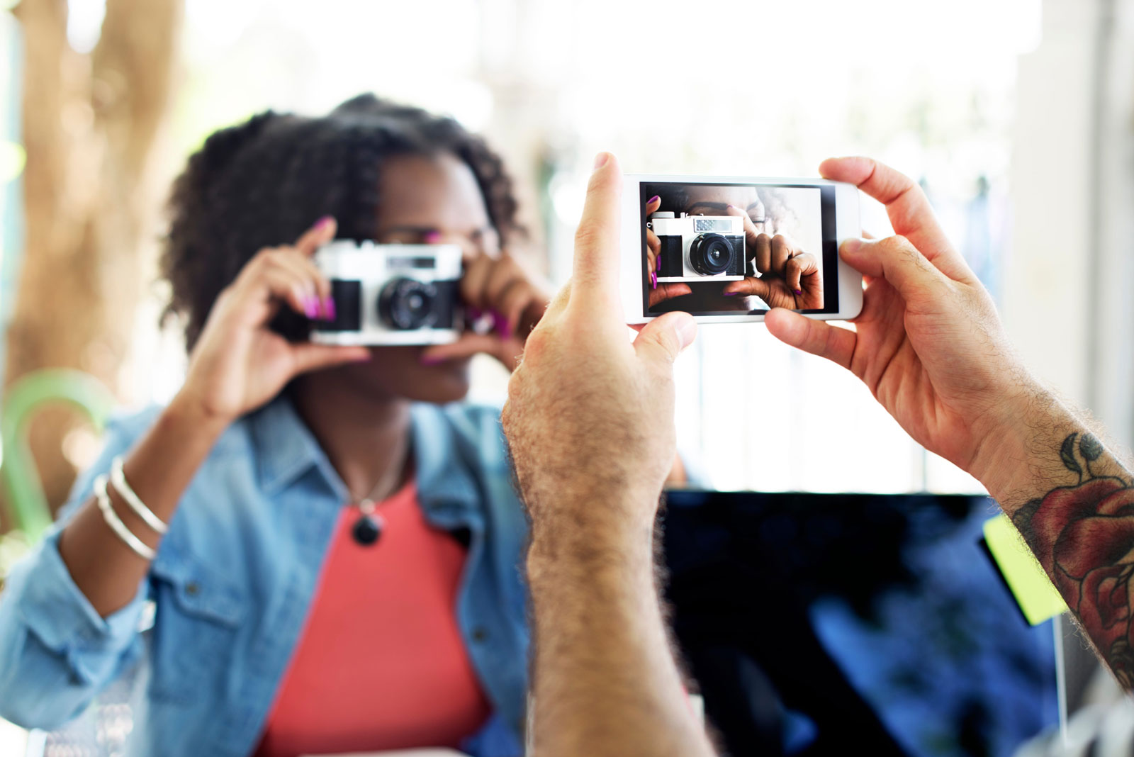 Taking a photograph of a person that is taking a photograph