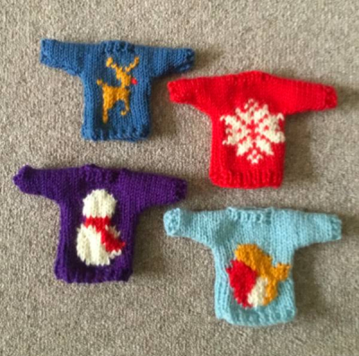 A photo of knitted Christmas jumper decorations