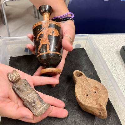 An Egyptian god, Greek vase and Roman oil lamp are held in an object handling tray.