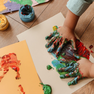 childs hands messy with paint