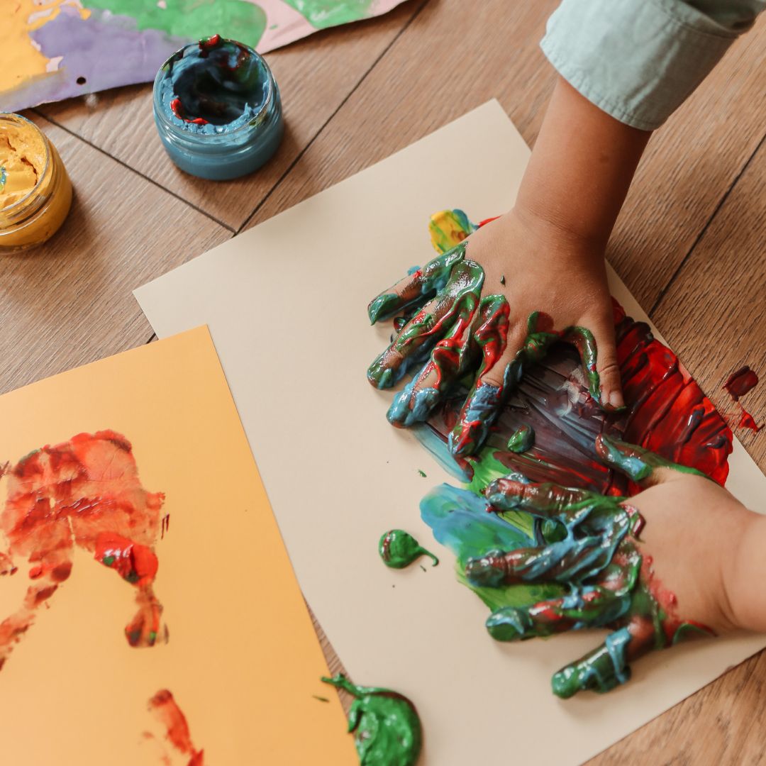 childs hands messy with paint