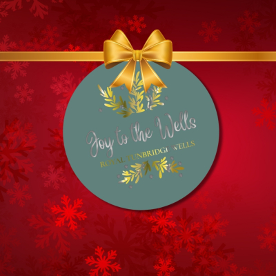 red christmas image with joy to the wells logo